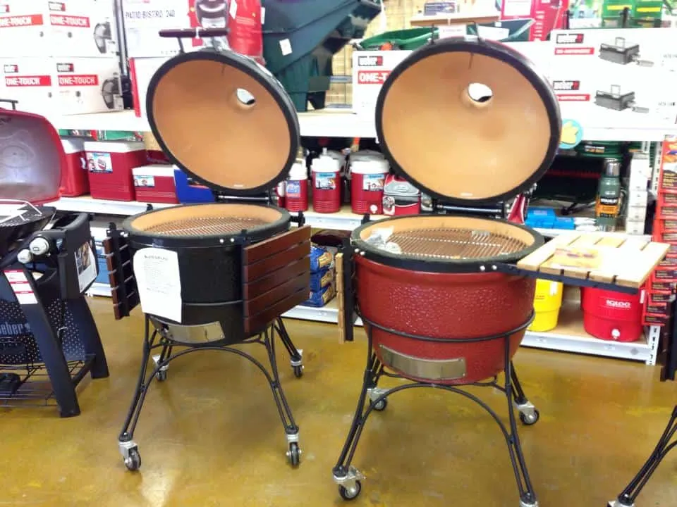 Two Kamado Joe ceramic grills with the lids open